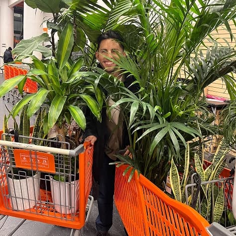 A teammate behind two carts full of plants